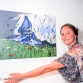 Hallie poses with one of her paintings
